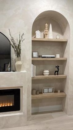 a living room with a fire place and bookshelves on the shelves in front of it