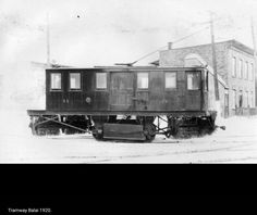 an old train car sitting in the snow