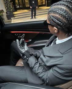 a woman sitting in the driver's seat of a car