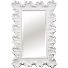 an ornate white mirror with scalloped edges