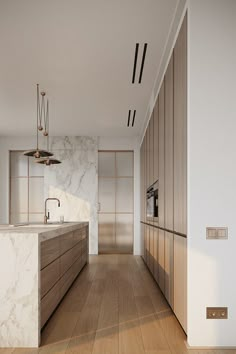 an empty kitchen with marble counter tops and wooden cabinets, along with wood flooring