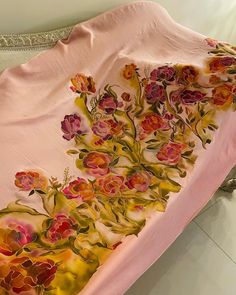 a pink bed spread with flowers on it