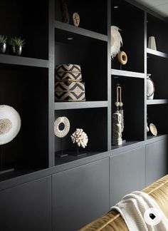 black shelves with decorative objects on them