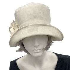 Handmade in the USAA hat isn't just about fashion, though the bespoke hats found here at Boston Millinery are the height of vintage style, it's about how you feel.It's about finding that finishing touch that make the corners of your lips uptick into a smile that shares your confidence and creativity.Wear this lovely Eleanor cloche hat to a garden party, the horse races, or an afternoon wedding and you’ll appear just as chic as Mary on Downton Abbey in today’s 20s. Meticulously crafted with care, Elegant Adjustable Bucket Hat With Flat Brim, Elegant Adjustable Flat Brim Bucket Hat, Elegant Adjustable Brimmed Bucket Hat, Fitted Beige Cloche Hat For Church, Classic Brimmed Top Hat For Spring, Cream Fitted Sun Hat With Flat Brim, Fitted Cream Panama Hat With Short Brim, Fitted Beige Cloche Hat, Church Hats With Short Brim