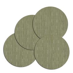 three circular coasters in green fabric with white dots on the top and bottom, set against