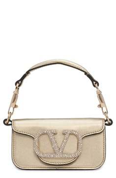 Create a sparkling finish to your look with a gilded handbag embellished with a crystal logo closure. Magnetic-snap closure Removable top carry handle; pull-through chain strap Structured silhouette with flat base for stability Leather Made in Italy Designer Handbags Trendy Purses, Crystal Logo, Valentino Bags, Pull Through, Metallic Leather, Chain Strap, Valentino Garavani, Snap Closure, Leather Shoulder Bag