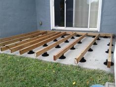 a wooden deck is being built in front of a house