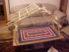 a living room area with a couch, rug and coffee table in the foreground