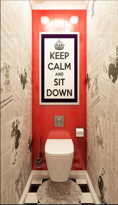 a toilet in a bathroom with newspaper on the wall and a poster above it that says keep calm and sit down