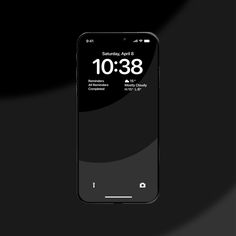 an iphone with the time displayed on it's display screen, in front of a black background