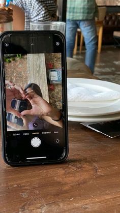 an iphone sitting on top of a wooden table