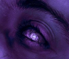 an eye is shown with purple light coming from the iris