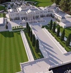 an aerial view of a large white mansion