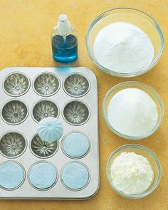 a muffin pan with cupcakes and other baking supplies