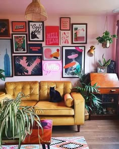 a living room filled with furniture and lots of pictures on the wall above it's couch