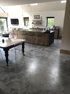 a large kitchen with an island in the middle and lots of counter space on one side