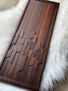 a wooden tray sitting on top of a white furnishing floor next to a rug