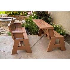 two wooden picnic tables sitting next to each other on top of a stone patio with flowers in the background