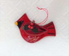 a red bird ornament hanging from a string