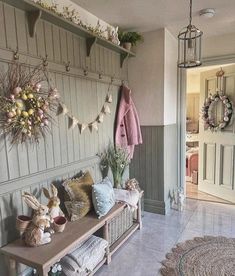 an entryway with several stuffed animals on the bench and wreaths hanging from the wall