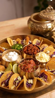 a plate filled with tacos and salsa on top of a table