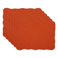 four orange placemats with wavy designs on each side and one in the middle