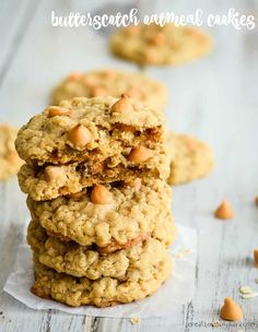 cookies stacked on top of each other with almonds scattered around them in the background