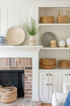 a living room filled with furniture and a fire place in front of a brick fireplace