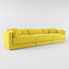 a yellow couch sitting on top of a white floor