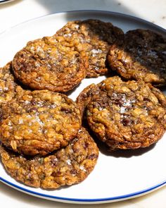 several cookies are on a plate with blue trim around the edges and white flecks