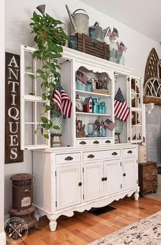 a white china cabinet with american flags on it