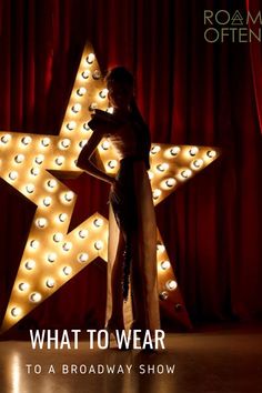 a woman standing in front of a star with the words what to wear to a broadway show