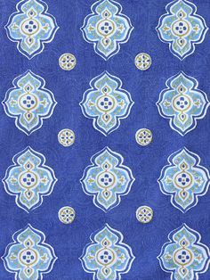 a blue and yellow fabric with an ornate design on it's side, in the middle