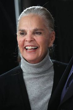 an older woman smiling and looking at the camera