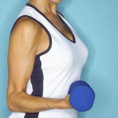 a woman holding a blue disc in her right hand and wearing a white tank top