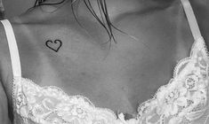 a woman with a heart tattoo on her chest