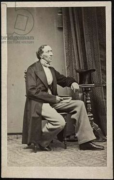 an old photo of a man sitting in a chair