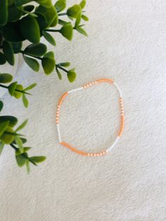 This orange beaded summer anklet is a cute accessory for any outfit and adds a pop of colour. It makes a great gift  for teens and adults. Trendy Summer Friendship Bracelets With Tiny Beads, Trendy White Beads For Summer, Casual Orange Friendship Bracelets For Beach, Trendy White Summer Beads, Colorful Beaded Anklets For Spring Gift, Casual Anklets With Round Beads For Vacation, Trendy Summer Anklets With Round Beads, Casual Round Beads Anklets For Vacation, White Beaded Bracelets For Spring Vacation