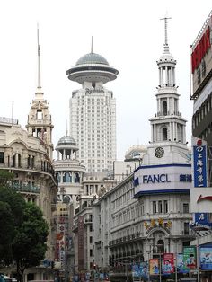 a busy city street with tall buildings in the background