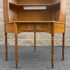 a wooden desk with two drawers on one side and an open drawer on the other