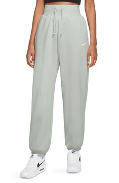 These high-rise sweats made of brushed fleece that fit loose through the hip and thigh are ready for the weekend. 29 1/2" inseam; 12" leg opening; 13" front rise; 18" back rise (size Medium) 80% cotton, 20% polyester Machine wash, tumble dry Imported High Rise Sweatpants, Outfit Ideas Christmas, High Waisted Sweatpants, Oversized Sweatpants, Nike Sportswear Women, Athletic Sweatpants, Baggy Sweatpants, Sweatpants Outfit, Nike Sweats