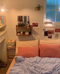 a bedroom with a bed, bookshelf and shelves on the wall above it