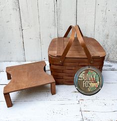 a wooden bench and foot stool next to a basket