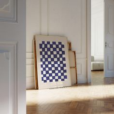 there is a blue and white checkered quilt on the floor