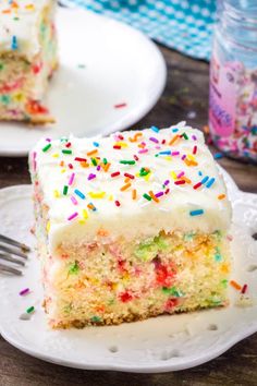 a slice of cake with white frosting and sprinkles