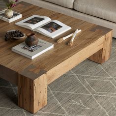 a coffee table with books and pictures on it