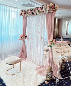 a pink and white wedding ceremony setup with flowers