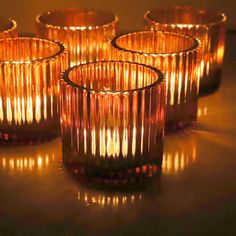 several lit candles sitting on top of a table