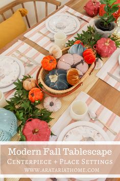 the table is set with plates, dishes and flowers on it's placemats