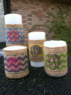 burlap wrapped jars with monogrammed letters on them sitting in front of a brick building